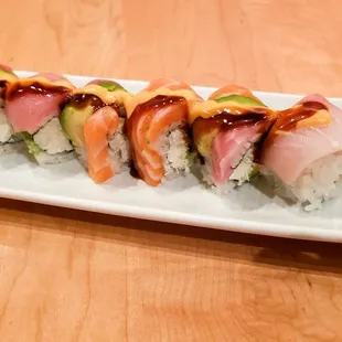 YZ Roll: Blue crab, avocado, and cream cheese, topped with tuna, salmon, yellowtail, whitefish, spicy mayo, and eel sauce.