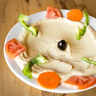 hummus with tomatoes, cucumbers, and olives