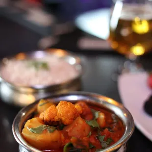 a bowl of stew and a plate of rice