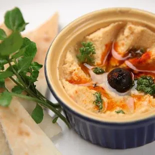 a bowl of hummus and pita bread