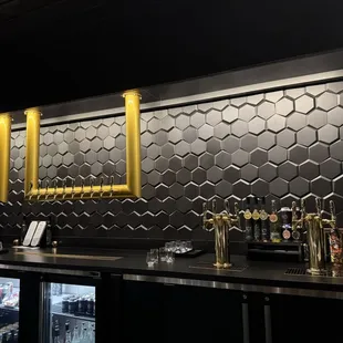 Bar backdrop made to look like honeycombs. Super cool.