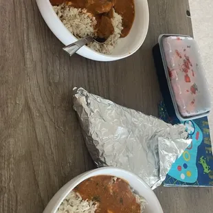 Rogan josh (left) and paneer shahi korma (right) in the foil is two orders of garlic naan and plastic container has the chicken 65