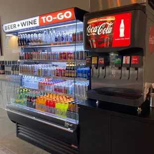 a soda cooler with sodas and soft drinks