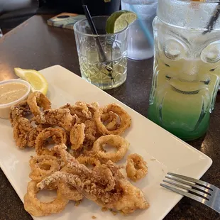 Calamari rings with there signature tangy sauce. Mermaid tail drink on the right and a whisky on the left. I had a few before taking the pic
