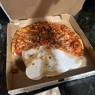 a half eaten pizza in a box