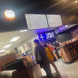 a man and a woman standing at a counter