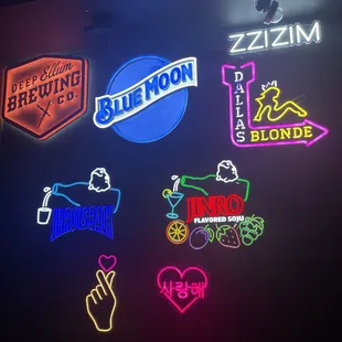various neon signs on a wall
