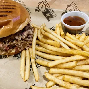 a pulled pork sandwich and fries