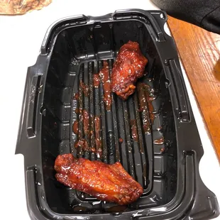 the chicken and ribs cooking on the grill